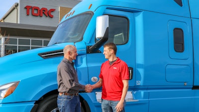 Roger Nielsen, CEO of Daimler Trucks North America LLC, (left) and Michael Fleming, CEO of Torc Robotics, celebrate the new partnership between their two companies.