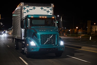 Volvo Vnr Electric Straight Truck With Van Body Front View On The Road Night Shot