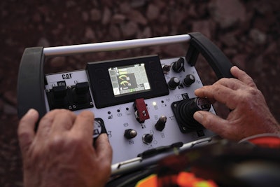 The Cat Command Console can be used to remotely operate an excavator on a hillside.