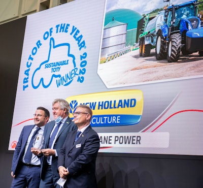 New Holland leadership accepts its Tractor of the Year award.