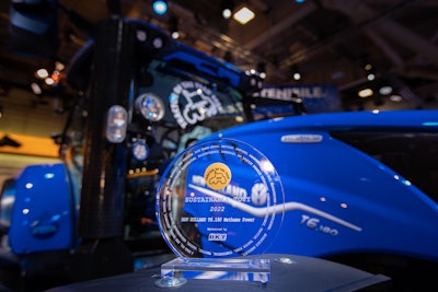New Holland proudly displays its Sustainable Tractor of the Year award in front of the winning machine, the T6 Methane Power tractor.