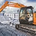 Hitachi Construction Machinery's parent company is selling half its shares in the business.