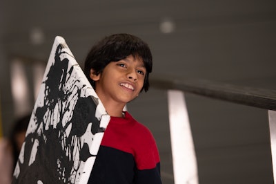 Advait_Kolarkar carries his Zebra Utopia artwork on a canvas. It was one of two pieces painted robotically.