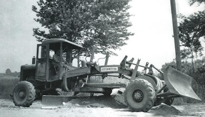 The first all-hydraulic motor grader was the Austin-Western 99. This 99-L version, equipped with an optional front dozer, is doing some road maintenance for owner Genessee County, New York, in 1958. (Austin-Western Collection)