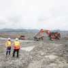 Two Mine Workers Having A Conversation Next To Machines (lube Expert Indonesia 2017) Source Photographic Services, Shell International Limited
