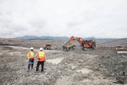 Two Mine Workers Having A Conversation Next To Machines (lube Expert Indonesia 2017) Source Photographic Services, Shell International Limited