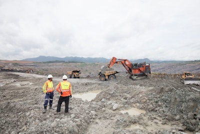 Two Mine Workers Having A Conversation Next To Machines (lube Expert Indonesia 2017) Source Photographic Services, Shell International Limited