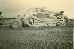 Not all of LeTourneau’s telescopic scrapers were unusually large. This Model LU Carryall has only an 11-yard heaped capacity, but this image shows the significant effect of the loading of the first of two buckets. It will soon be moved back, and the second bucket will load in its place.