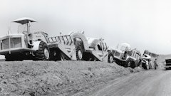 Get a machine with so much play in it too close to the edge of a berm, and this is bound to happen. The bowls have found a stable position, with only the lead TS-14 fully on level ground. The gentlemen at the No. 4 bowl are Euclid engineers: Left to right, Ray Trumphour, Terry Cunningham and Bill Walker. They’re working on the hydraulic lines in the gooseneck – something not normally done from ground level!