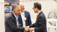 Wallenius Wilhelmsen COO of Logistics Services John Felitto (l) and Senior Vice President of High & Heavy Services Americas Mike Rye (c) congratulate HD Hyundai XiteSolution President and CEO Young Cheul Cho on the opening of the new HD Hyundai North American Customization Center.