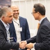 Wallenius Wilhelmsen COO of Logistics Services John Felitto (l) and Senior Vice President of High & Heavy Services Americas Mike Rye (c) congratulate HD Hyundai XiteSolution President and CEO Young Cheul Cho on the opening of the new HD Hyundai North American Customization Center.