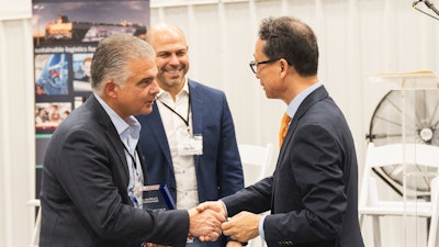 Wallenius Wilhelmsen COO of Logistics Services John Felitto (l) and Senior Vice President of High & Heavy Services Americas Mike Rye (c) congratulate HD Hyundai XiteSolution President and CEO Young Cheul Cho on the opening of the new HD Hyundai North American Customization Center.