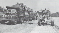 Figure 1: One advantage of a motor grader/EGA outfit was that it required only one operator. But in some loading situations, a spotter rode out on the parent’s frame to direct hauler traffic, somewhat negating the labor savings. Courtesy: Ulrich Manufacturing Company Form 1231, n. d., HCEA Archives