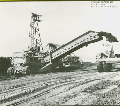 One of the four Holland loaders at Perris Dam makes quick work of loading a 110-ton capacity Euclid bottom dump. It’s equipped with a vertical cutting edge.