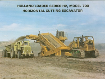 A later Holland Series H2 Model 700 loader. Note that the flow of material upward is along rather than across the direction of travel. It excavates like a scraper with a horizontal blade.