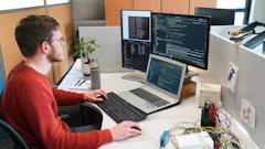 Figure 1: A software engineer at Dintec developing code for off-highway machinery.