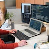 Figure 1: A software engineer at Dintec developing code for off-highway machinery.