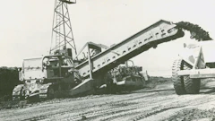 One of the four Holland loaders at Perris Dam makes quick work of loading a 110-ton capacity Euclid bottom dump. It’s equipped with a vertical cutting edge.