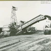 One of the four Holland loaders at Perris Dam makes quick work of loading a 110-ton capacity Euclid bottom dump. It’s equipped with a vertical cutting edge.