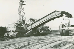 One of the four Holland loaders at Perris Dam makes quick work of loading a 110-ton capacity Euclid bottom dump. It’s equipped with a vertical cutting edge.