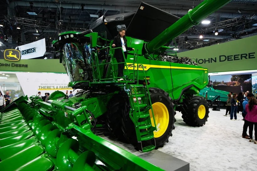 An attendee experiences the X9 1100 combine at John Deere's booth at CES 2026 in January.