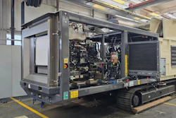 Mobile diesel generator unit with engine compartment open on industrial trailer in factory workshop