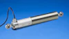 Linear position transducer with silver metal housing, white connector body, and dual mounting brackets on blue background