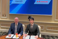 Two businessmen sign documents at formal meeting with Rexroth and Kawasaki logos displayed on screen behind them
