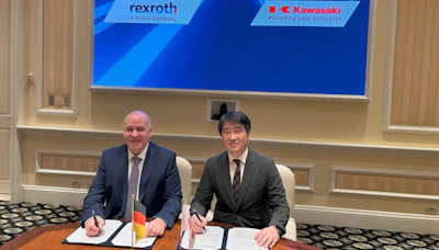 Two businessmen sign documents at formal meeting with Rexroth and Kawasaki logos displayed on screen behind them